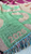 Green fabric with embroidered numbers '2026' on a colorful background